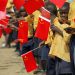 Liberian children hold Chinese flags before the arrival of China's President Hu Jintao in Monrovia February 1, 2007. Thousands of cheering Liberians lined the streets of the capital Monrovia on Thursday to greet Hu, hoping for desperately needed investment for their war-scarred nation. REUTERS/Christopher Herwig (LIBERIA) - RTR1LVK9