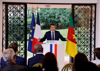 French President Emmanuel Macron (C) delivers a speech during a meeting with African business leaders about Farm initiatives at the French Embassy in Yaounde, on July 26, 2022, as part of an official visit. - French President Emmanuel Macron on Tuesday asked historians to "shed light" on France's actions in Cameroon during colonisation and after the country's independence, announcing the "full" opening of French archives on "painful" and "tragic" moments. (Photo by Ludovic MARIN / AFP)